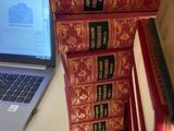 books stacked on top of each other on a desk next to a laptop