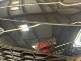 a close up of a car ' s grille with a reflection on it