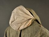 a man wearing a jacket with a hood over his head