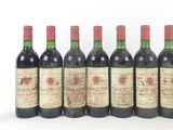 several bottles of wine are lined up in a row