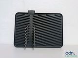 an image of a black grill pan with a pair of tongs in it