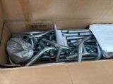 a cardboard box with a bunch of metal pipes in it