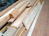 many pieces of wood on the floor in the warehouse