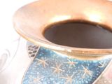 a blue and gold vase sitting on a table