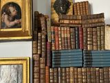 many old books on a shelf in a room