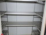 a white refrigerator with shelves and shelves in a room