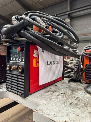 a lot of welding equipment on a table in a warehouse