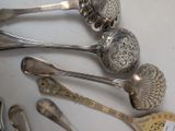 a lot of silver spoons and spoon spoons on a table