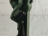 statue of a man sitting on a pedestal with his hands on his knees