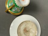 a cup and saucer sitting on a table next to a plate