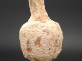 a small vase that is sitting on a stand