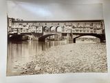 a black and white photo of a bridge over a river