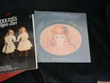 two books that are sitting on a black cloth