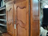 a large wooden cabinet in the middle of a room