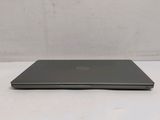 the back of a dell laptop computer sitting on top of a white table