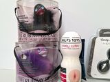 a plastic container with a toy in it next to other items