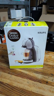 a box on a table with a coffee maker inside of it