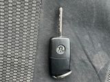 a car key sitting on the seat belt of a car