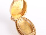 yellow gold locke with a face of a man in the center