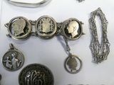 many different types of jewelry on display on a table