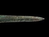 a close up of a very old metal object on a black background