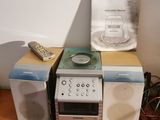 several speakers and a remote sitting on a table