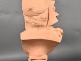 an image of a clay bust of a woman on a pedestal