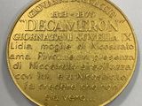 a close up of a gold coin on a white surface