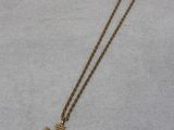 a gold necklace with a cross on it