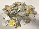 a pile of silver and gold coins on a white table