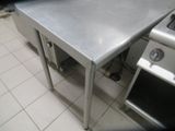 a stainless steel table in the middle of a kitchen
