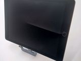 a tablet that is sitting on a stand on a table