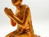 golden buddha statue on white background with copy space for text
