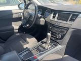 the interior of a car with a steering wheel and dashboard controls