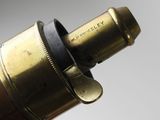 a close up of a brass telescope with a wooden handle
