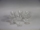 four wine glasses sitting on a table with a white background
