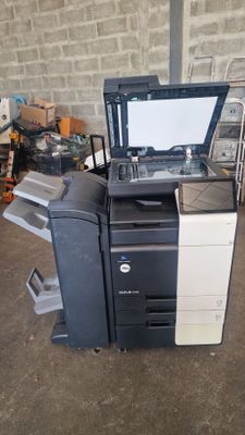 a printer sitting on top of a cart in a garage