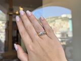 a woman ' s hand with a ring on it