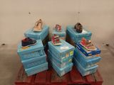 several pairs of shoes are stacked on top of boxes on a pallet