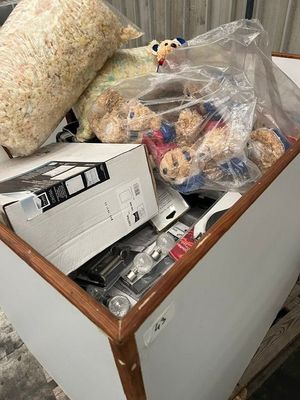 a box full of stuffed animals and other items in it