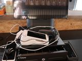 a computer monitor sitting on top of a desk with a lot of wires