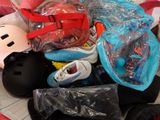 a pile of assorted skateboard gear on a bed