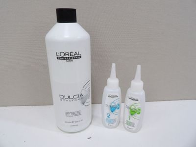 a picture of a bottle of shampooe and two bottles of lotion