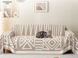 a cat that is sitting on a couch in the living room