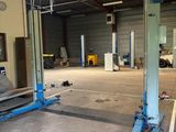 an image of a garage with a car in the middle of it