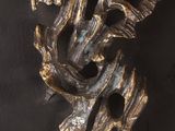 a close up of a metal object on a black surface