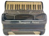 an old accordion with the words magnan perfect written on it