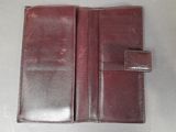 a brown leather wallet sitting on top of a table
