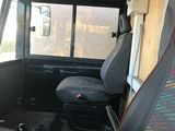 a seat in the back of a bus with a laptop on it