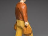 figurine of a man with a hat and yellow pants